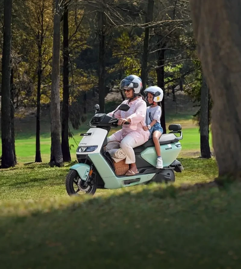 Two riders traveling on an Ather Rizta electric scooter in an official product photograph; source: Ather Energy