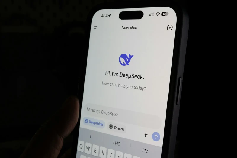 A smartphone displaying the DeepSeek application beside a laptop