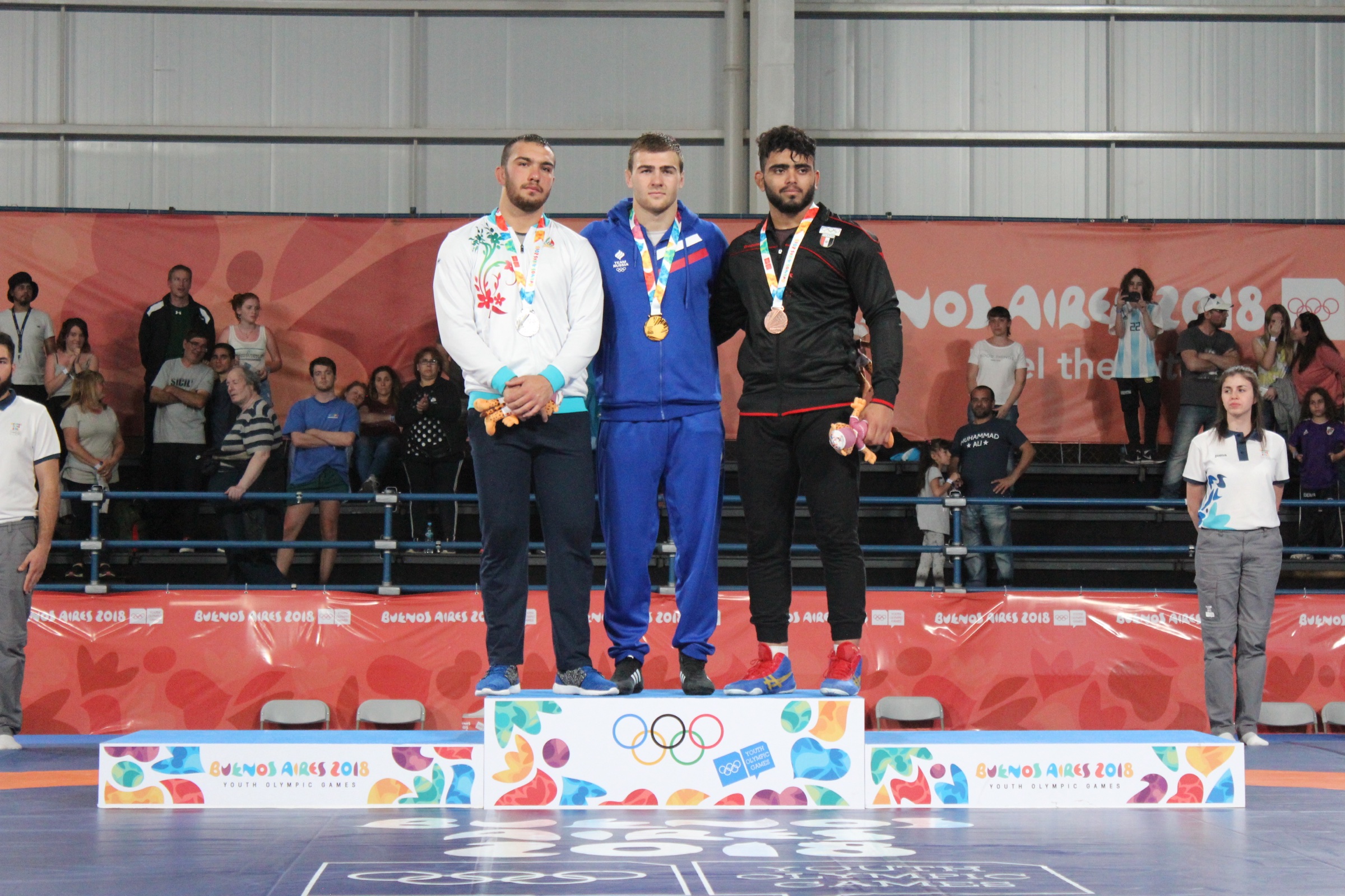 Amir Hossein Zare, left, on the 2018 Youth Olympic wrestling podium.