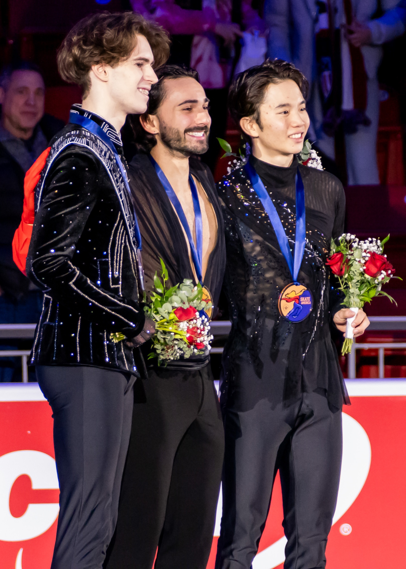 Mikhail Shaidorov, left, at the 2025 Skate America victory ceremony.
